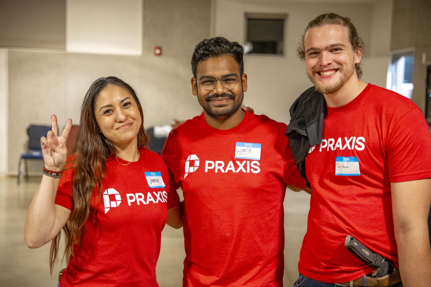 Waris Hussain with Praxis teammates Jamie and Joshua in Praxis shirts at Praxis Weekend, the annual alumni meetup